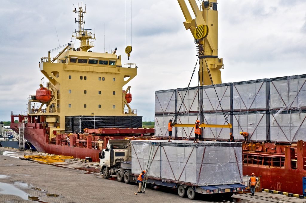 Loading cargo into the ship in harbor